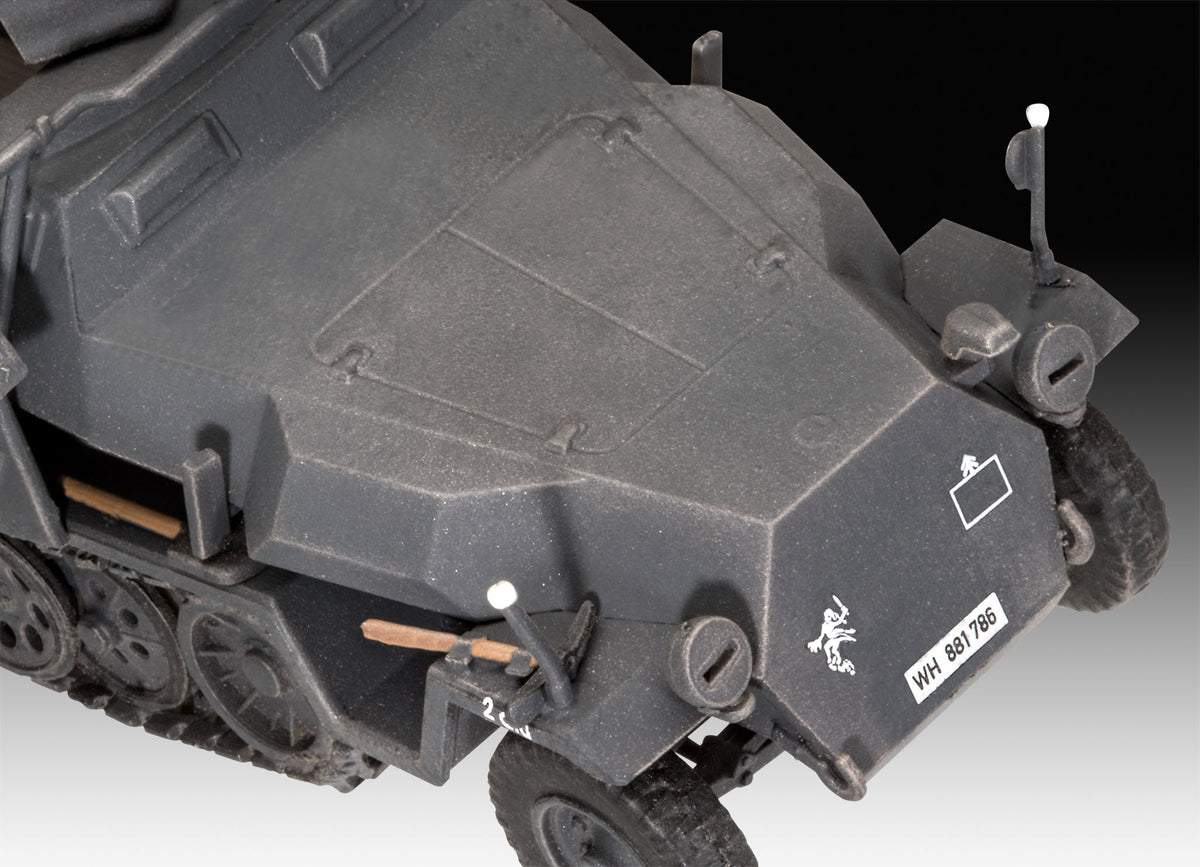 Close-up view of armored hood plates, license decal, width indicators, and pioneer tools.